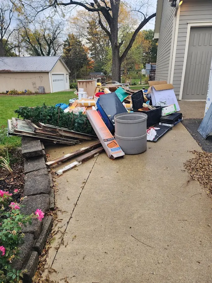 Dumpster being loaded with debris for Roofing Dumpster Rental in Tiger Point